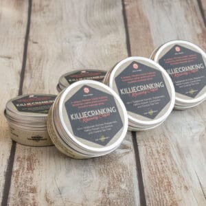 Five tins of Killiecranking Koorivy Recovery Cream are arranged on a wooden surface. Trail Science Recovery Cream